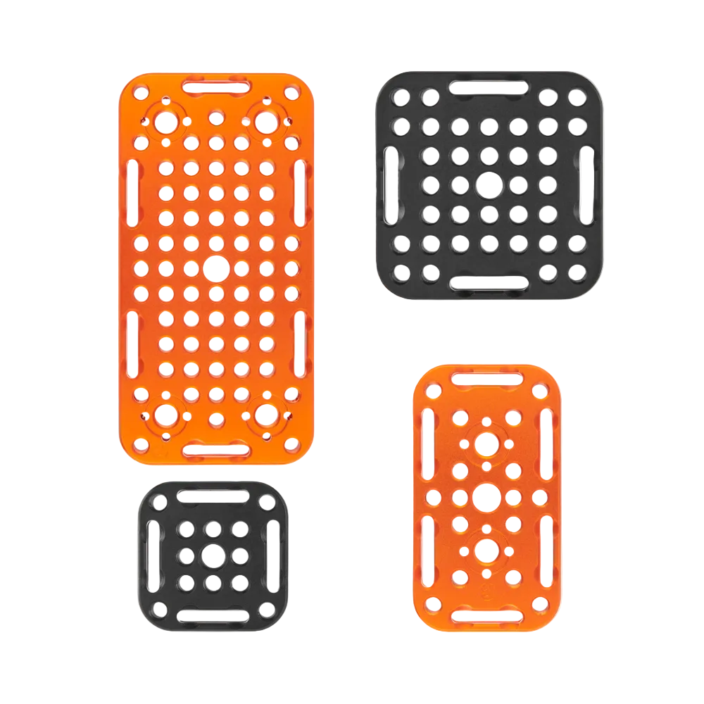 Four plastic mesh racks in orange and black on a white background